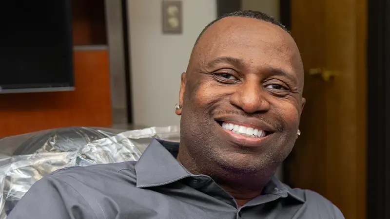 Confident patient with beautiful smile with implants