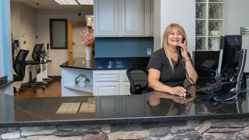 Front desk team member taking call