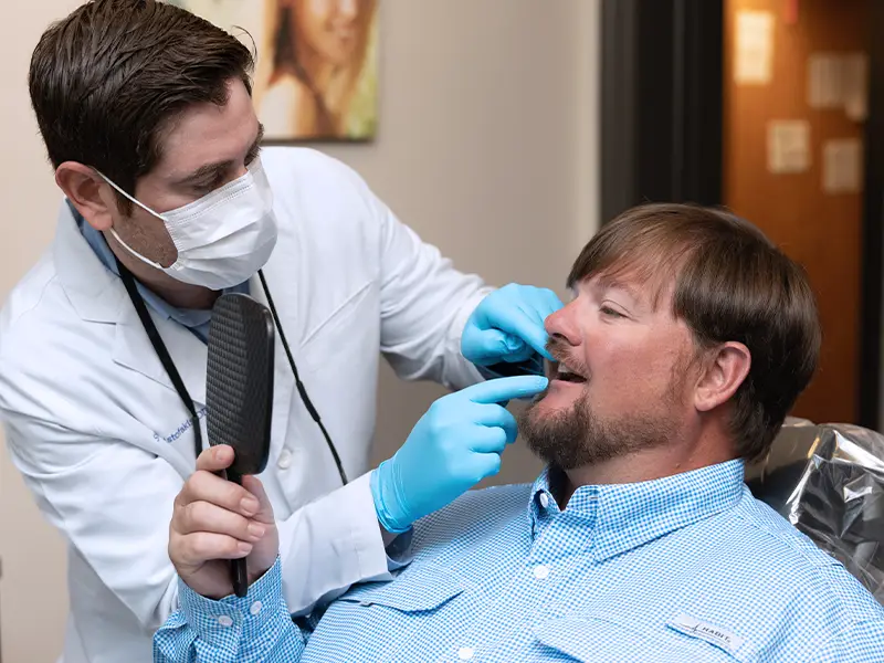 Dentists examines patient
