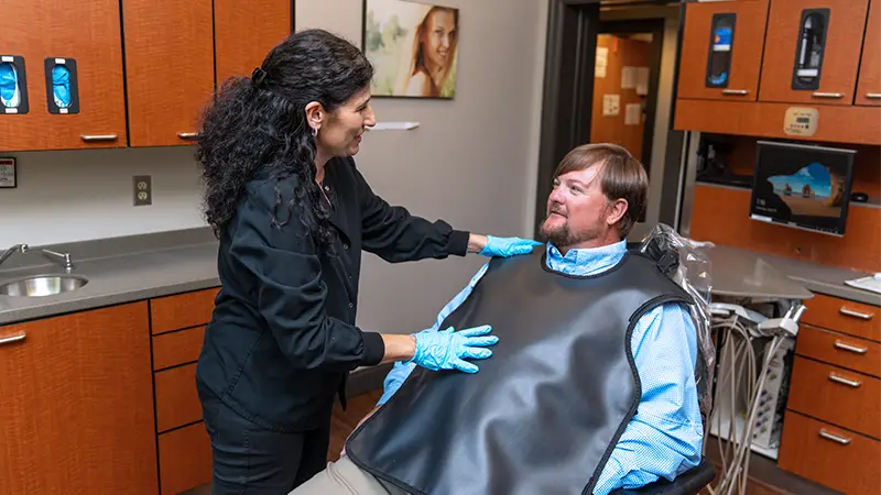 Hygienist making patient comfortable before a scan