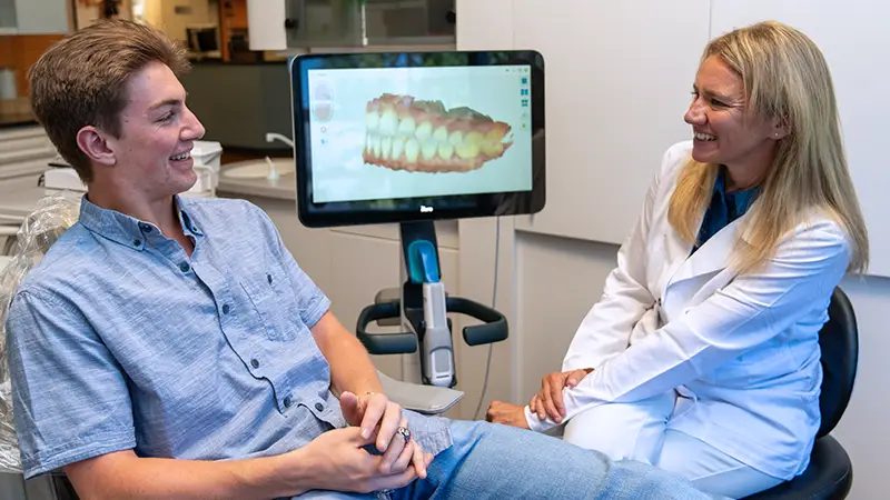 dentist Sparks and patient reviewing scans