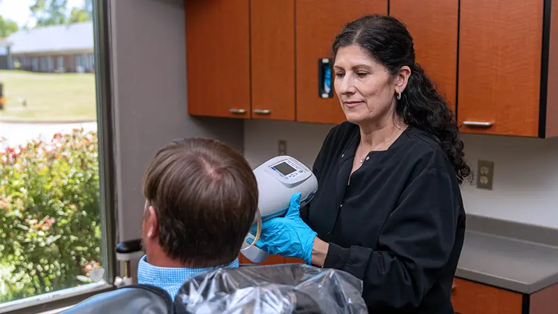 hygienist scanning patient in operatory
