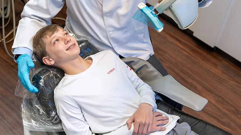Teen patient in dentist chair