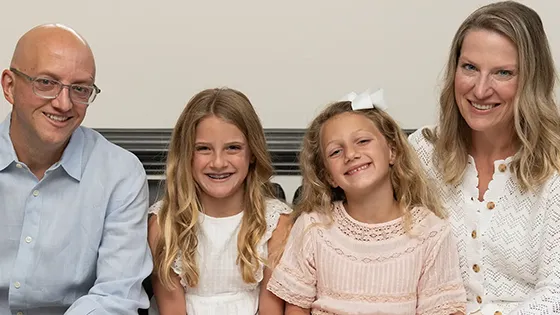 family smiling in lobby