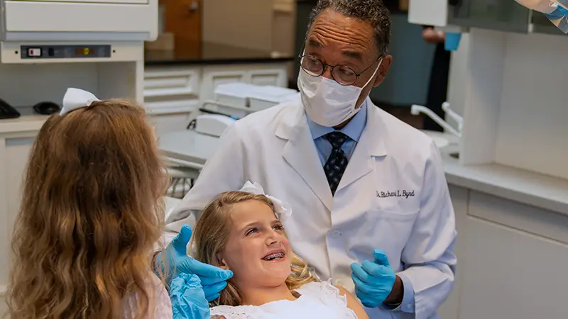 Orthodontist talking to young patients