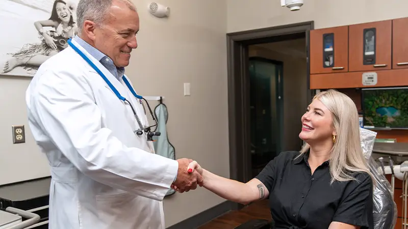 Dr and hygienist examining patient for veneers