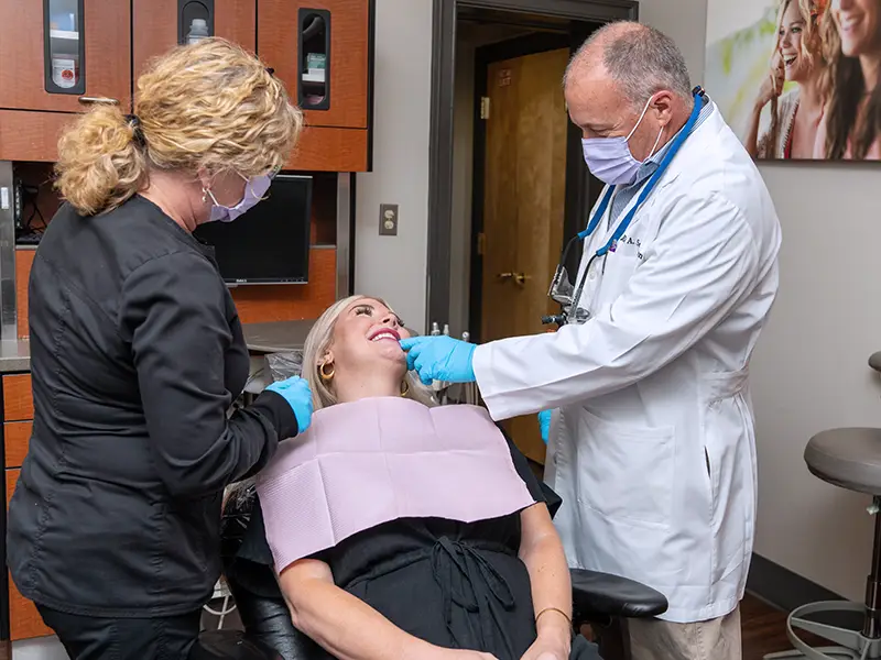 Doctor and hygienist examining patients teeth